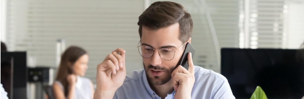 Sales Manager Consulting Client Talking On Phone In Office
