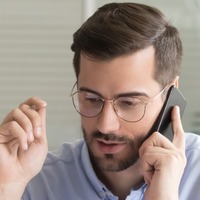 Sales Manager Consulting Client Talking On Phone In Office